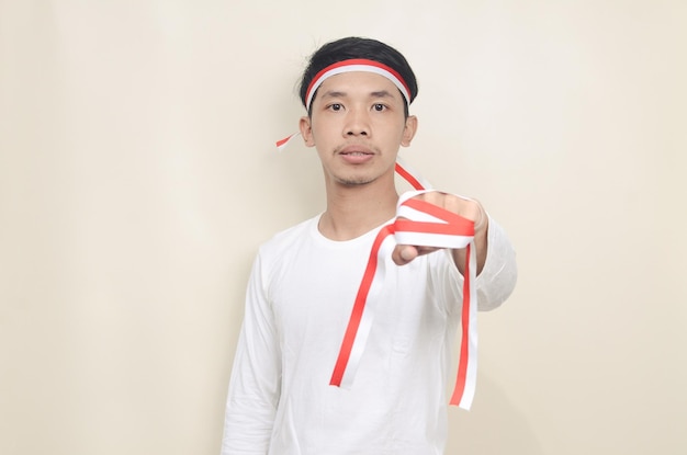 Asian man celebrating independence day while standing and clenching his hand