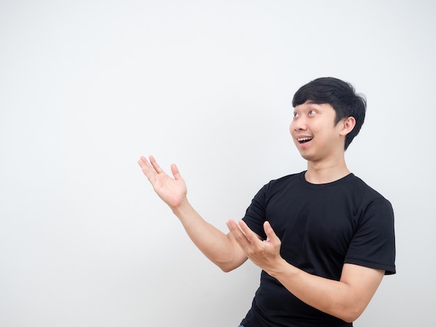 Asian man cheerful pointing hand at side present product concept copy space
