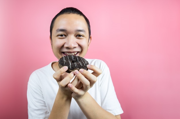 Asian man eating a delicious donut