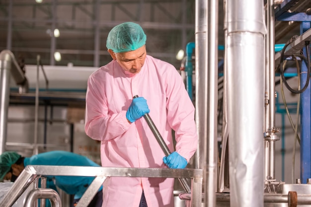 Asian man employee working in food Factory industry