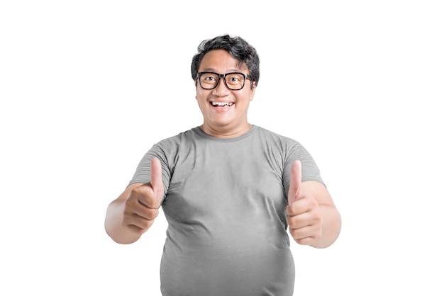 Asian man in eyeglasses showing thumb up with excited expression isolated over white background