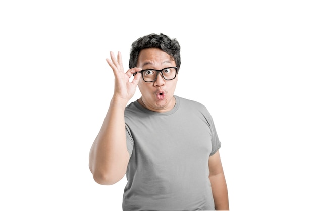 Asian man in eyeglasses with excited expression isolated over white background