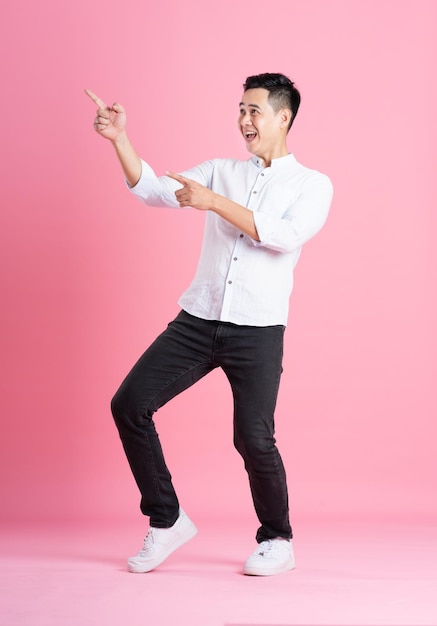 Asian man full body image isolated on pink background