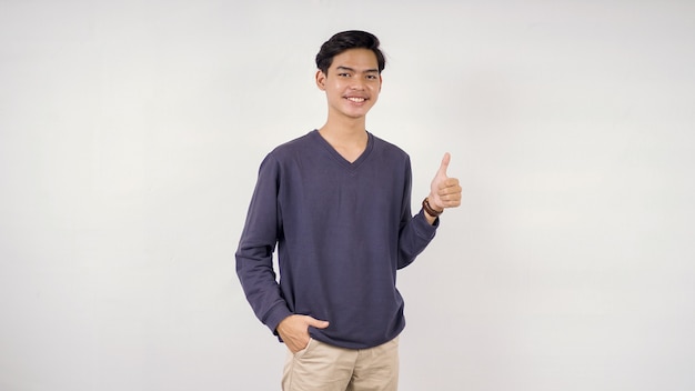 Asian man giving a thumbs up isolated on a white background