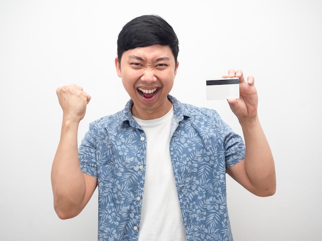 Asian man happy with credit card in hand and fist up success