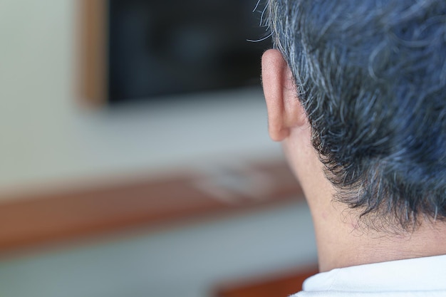 Asian man having grey and white hair growing up Hair problem concept