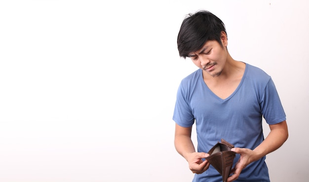 Asian man holding an empty wallet on white background.