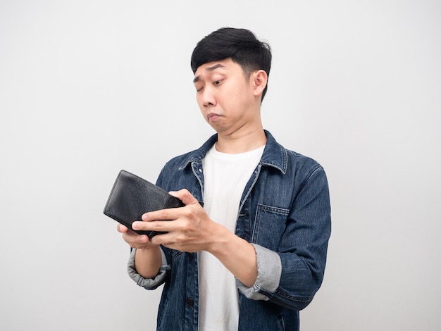 Asian man jean shirt don't dare to look at his wallet because no money