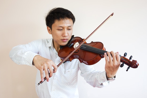 Asian man playing violin. 