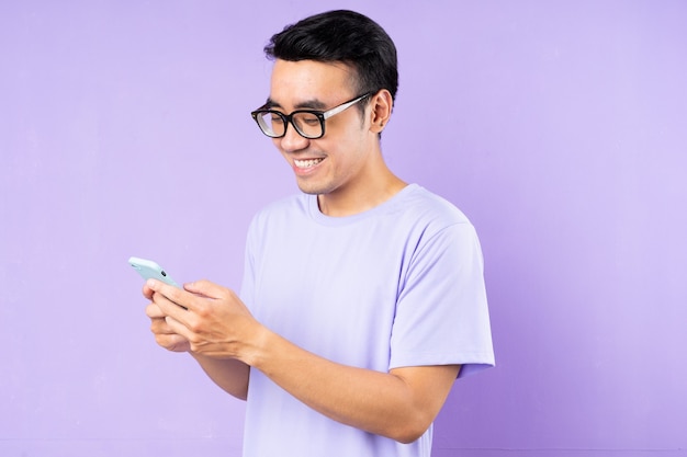 Asian man portrait, posing on purple background