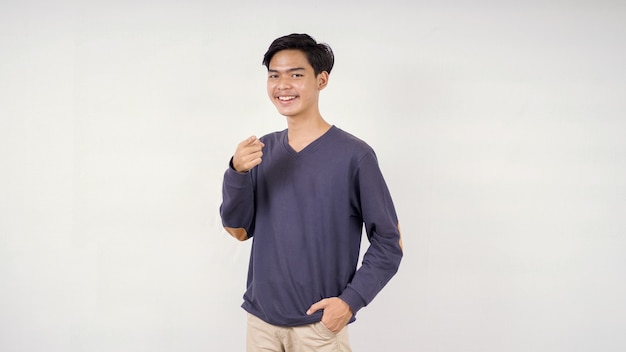 Asian man posing pointing forward with smiling expression isolated on white background