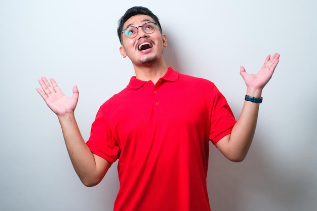 Asian man receiving something from above gesture happy smiling excited winning expression