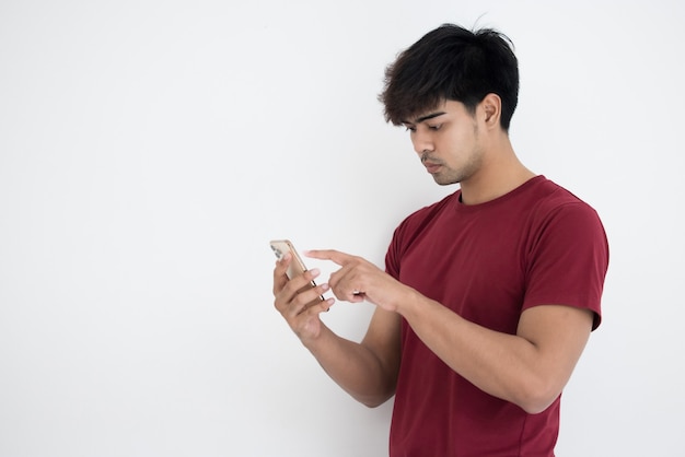 Asian man in red t-shirt using smartphone