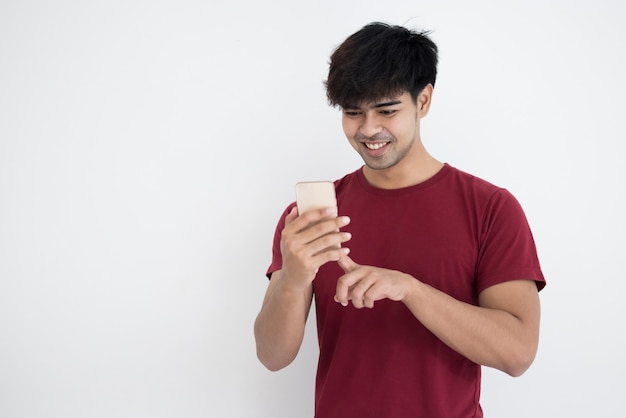 Asian man in red t-shirt using smartphone