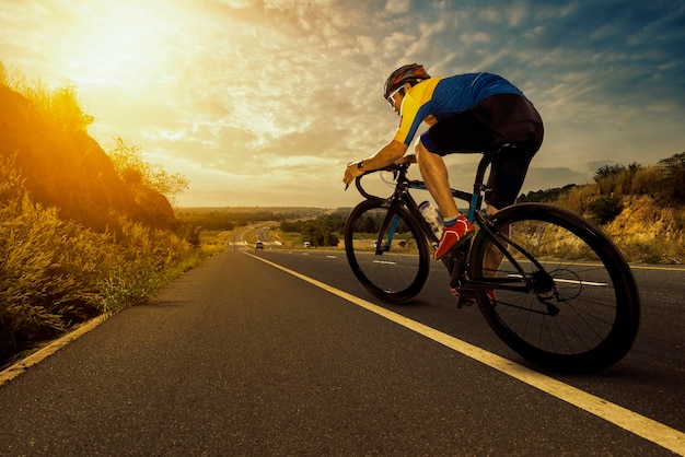 Asian man riding a bicycle on an open road