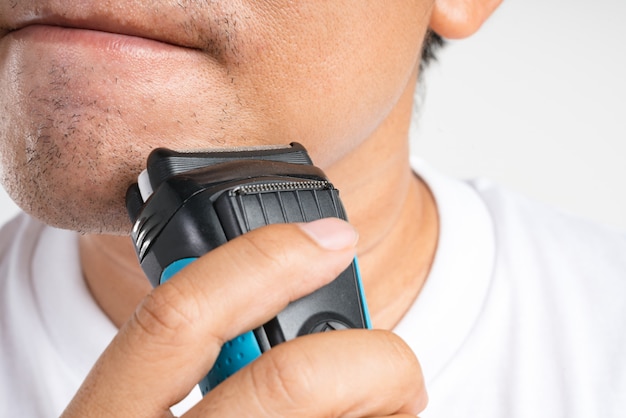 Asian man shaving his new short beard