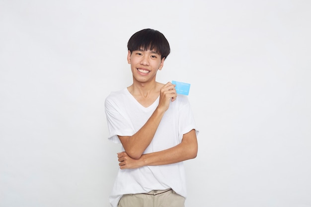 Asian man showing credit card payment concept isolated on white surface