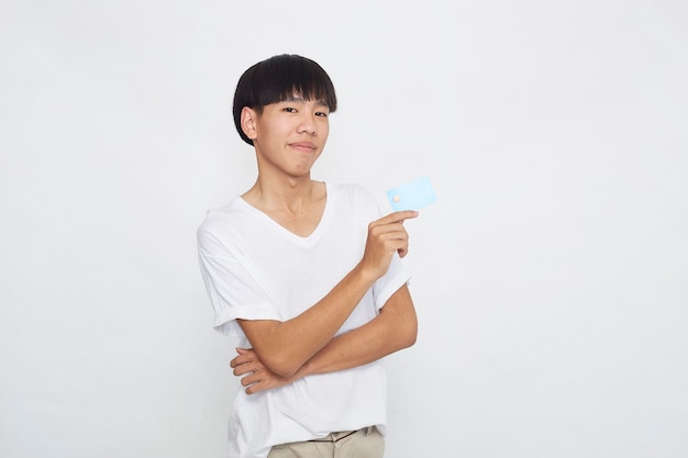 Asian man showing credit card payment concept isolated on white surface