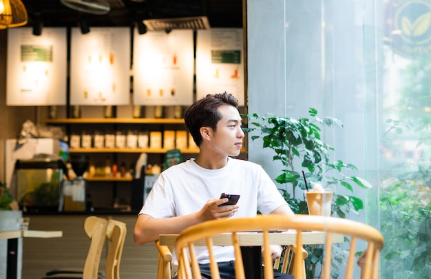 Asian man sitting at coffee shop