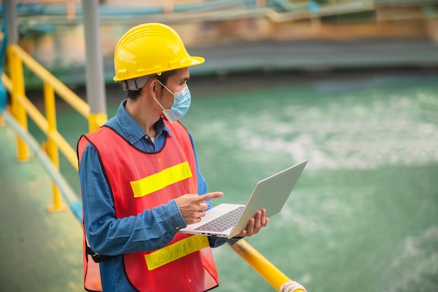 Asian man technician worker inspecting key condition control in water treatment factory