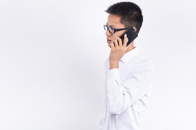 Asian man use smartphone on gray background young man play mobile phone