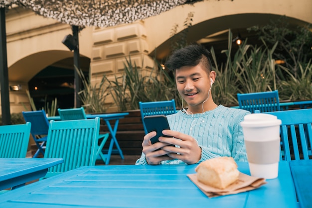 Asian man using his mobile phone.