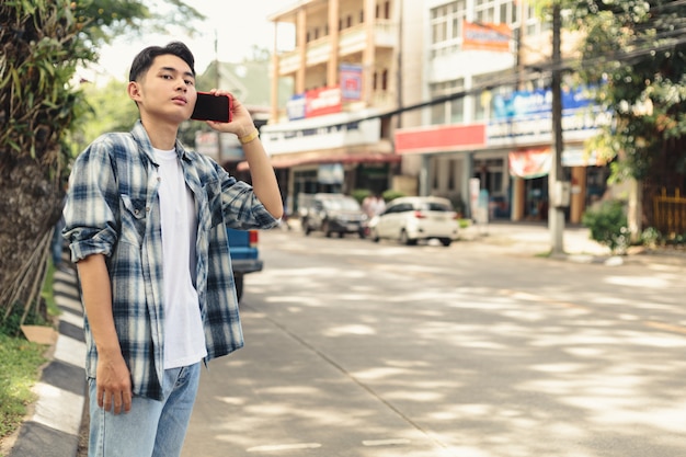 Asian man waiting for Uber taxi