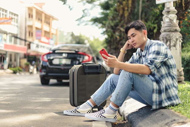 Asian man waiting for Uber taxi