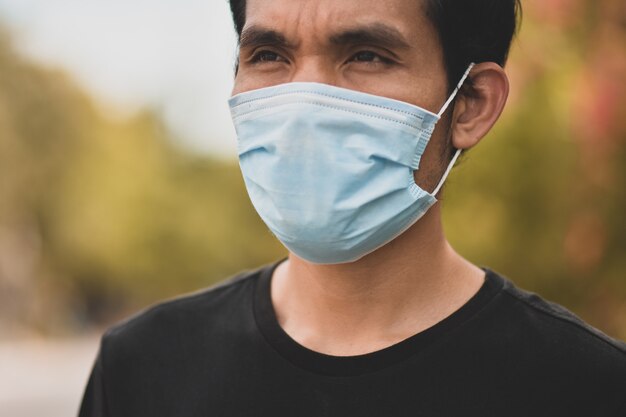 Asian man a wearing face mask concept new normal social distancing