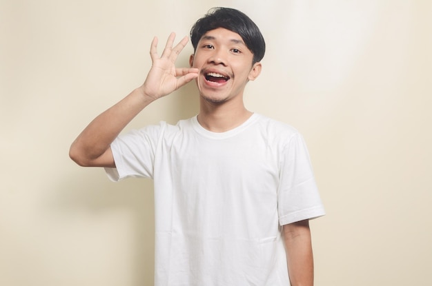 Asian man wearing white tshirt with gesture showing delicious meal on isolated background