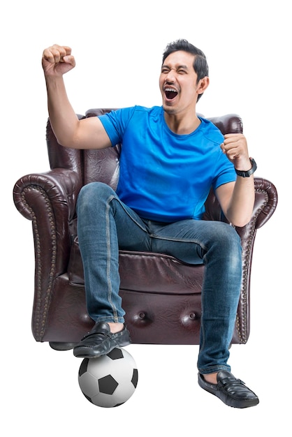 Asian man with the ball sitting on the couch with an excited expression