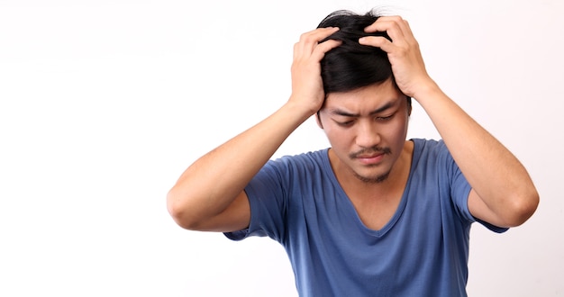 Asian man with a headache on White background.