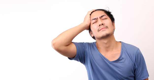 Asian man with a headache on White background.