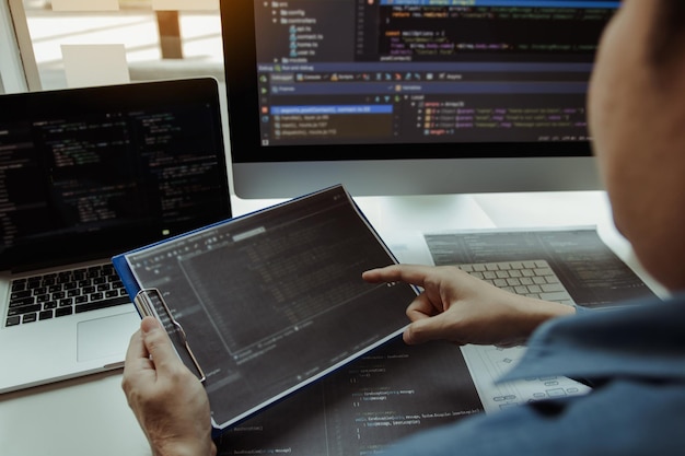 Asian man working code program developer computer web development working design software on desk in office