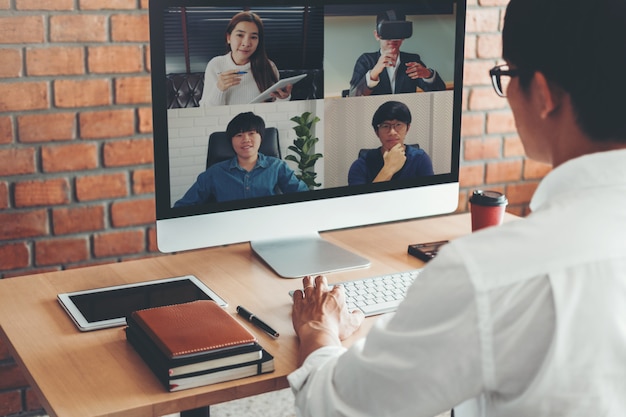 Asian man working from home and having videocall