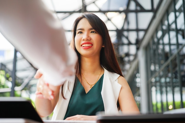 asian manager woman hand shake with graduated person after job interview 