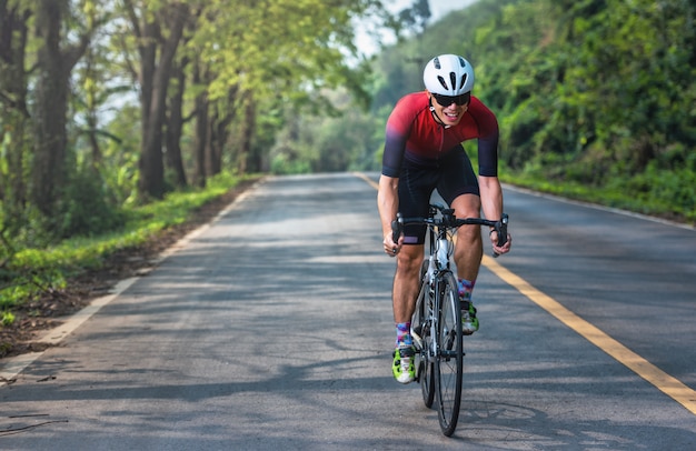 Asian men are cycling road bike in the morning