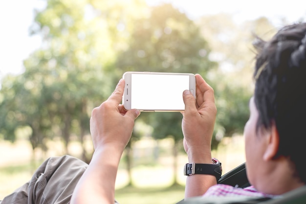 Asian men are using smartphone in the park.