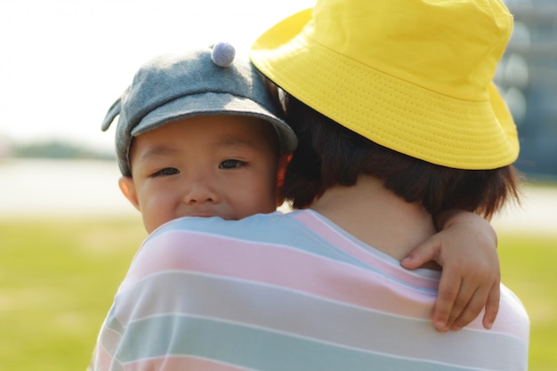 Asian mother carry toddler baby boy