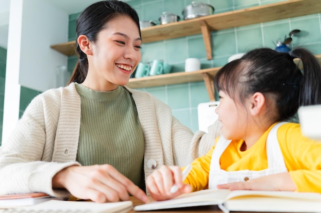 Asian Mother and daughter studying together at home