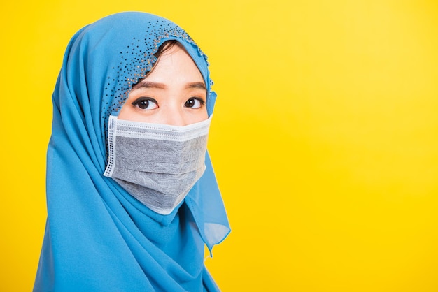 Asian Muslim Arab, Portrait of happy beautiful young woman religious wear veil hijab smiling studio shot isolated, yellow background with copy space, Close up skin face