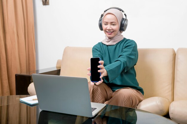 Asian Muslim businesswoman using a laptop working from home. Prevent flu disease Coronavirus