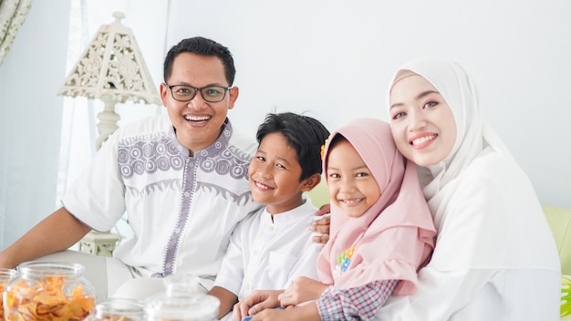 Asian Muslim families celebrate Eid together while enjoying a meal