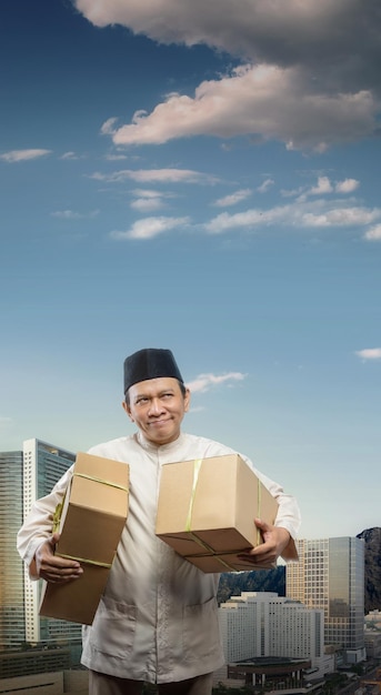 Asian Muslim man carrying box ready to mudik on the street