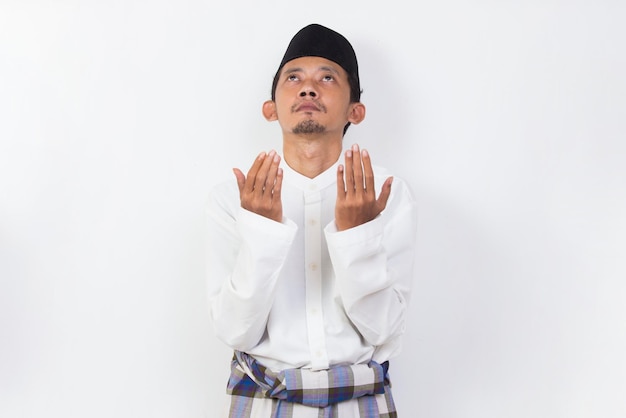 asian muslim man praying isolated on white background