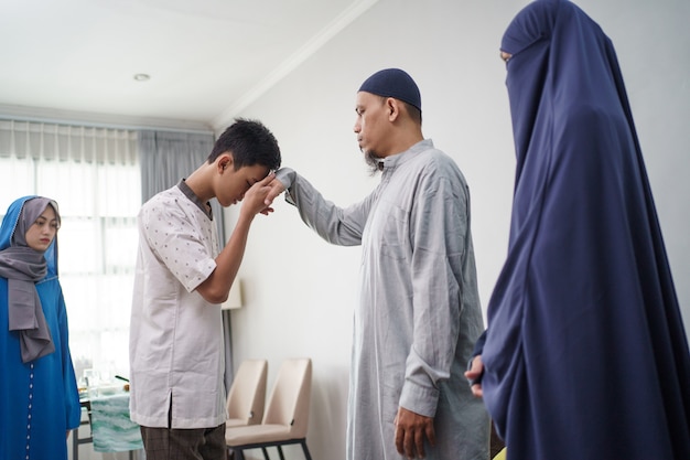 Asian muslim parent shake hand in idul fitri eid mubarak