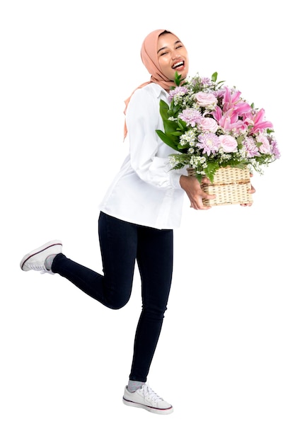 Asian Muslim woman in a headscarf holding a flower bucket