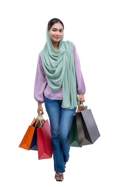 Asian Muslim woman in a headscarf holding shopping bags