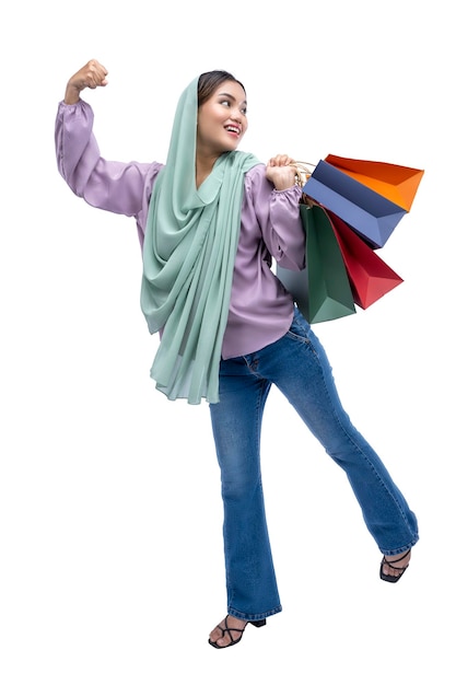 Asian Muslim woman in a headscarf holding shopping bags