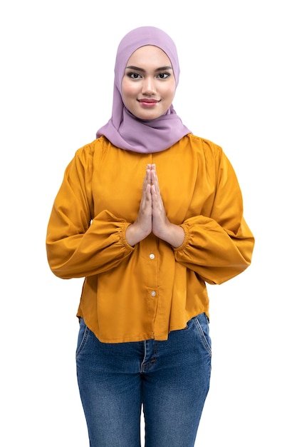 Asian Muslim woman in a headscarf with a greeting gesture